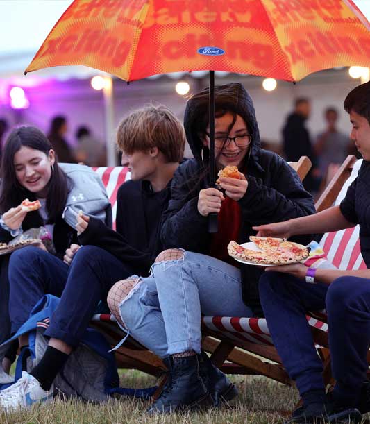 people enjoying pizza outside at Waterbeach outdoor cinema