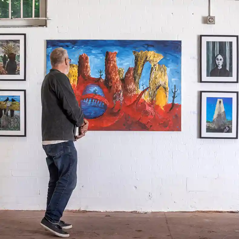 A man looking at a painting